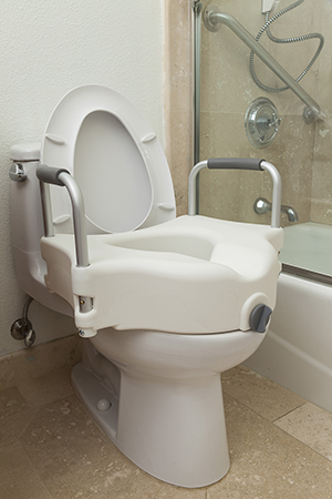 Commode seat on toilet.