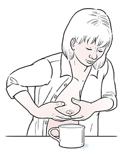 Woman hand-expressing breast milk.