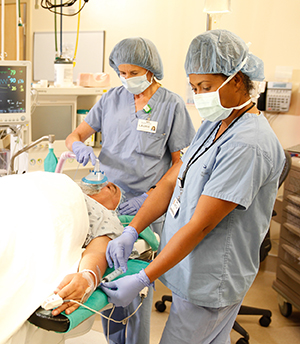 Healthcare providers in operating room preparing man for surgery.